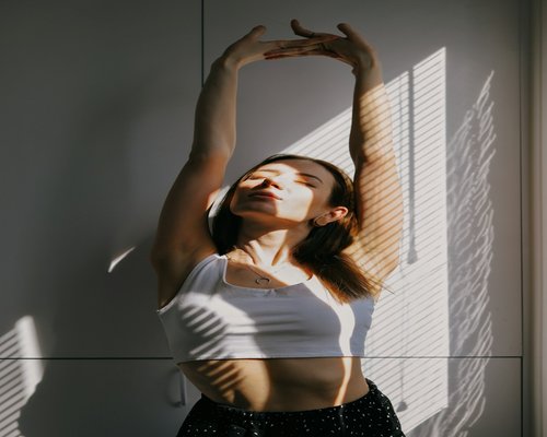 A person engaging in light stretching and deep breathing exercises